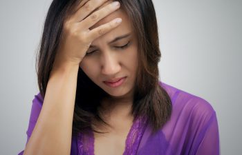 depressed woman suffering from headache