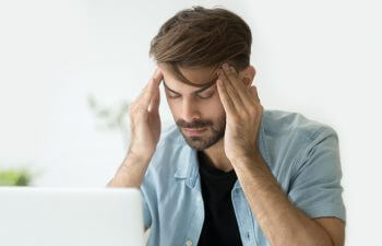 young man suffering from headache