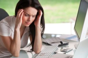 A young woman suffering from severe headache.