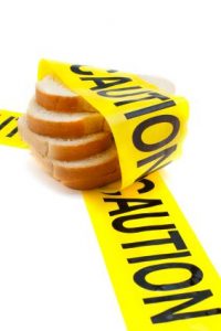 bread wrapped with a yellow warning tape that reads caution