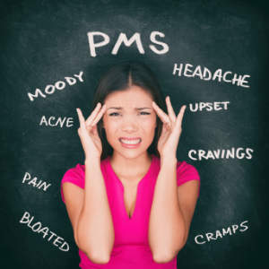 Annoyed woman suffering from headache due to PMS syndrome.